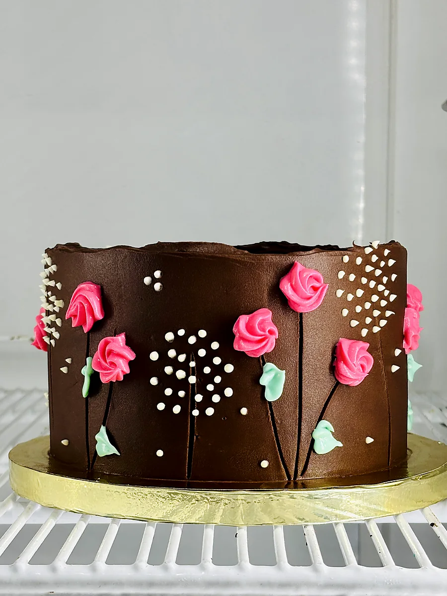 Chocolate cake with piped pink roses