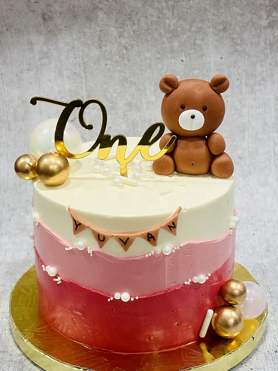Pink ombre first birthday cake with teddy